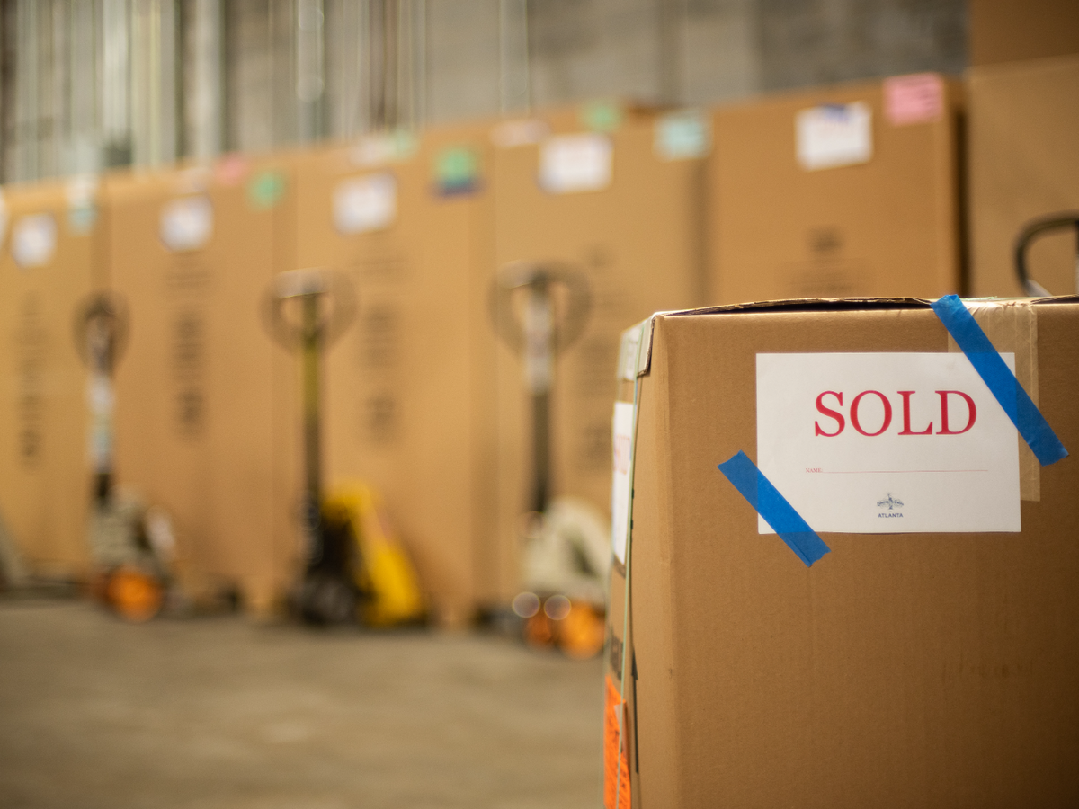 Cardboard boxes with sold on the closest one