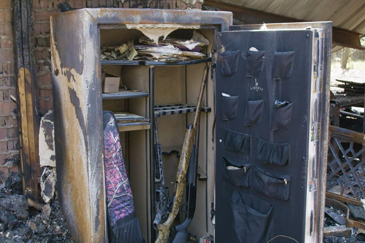 Burnt and damaged safe with open doors showing interior contents.