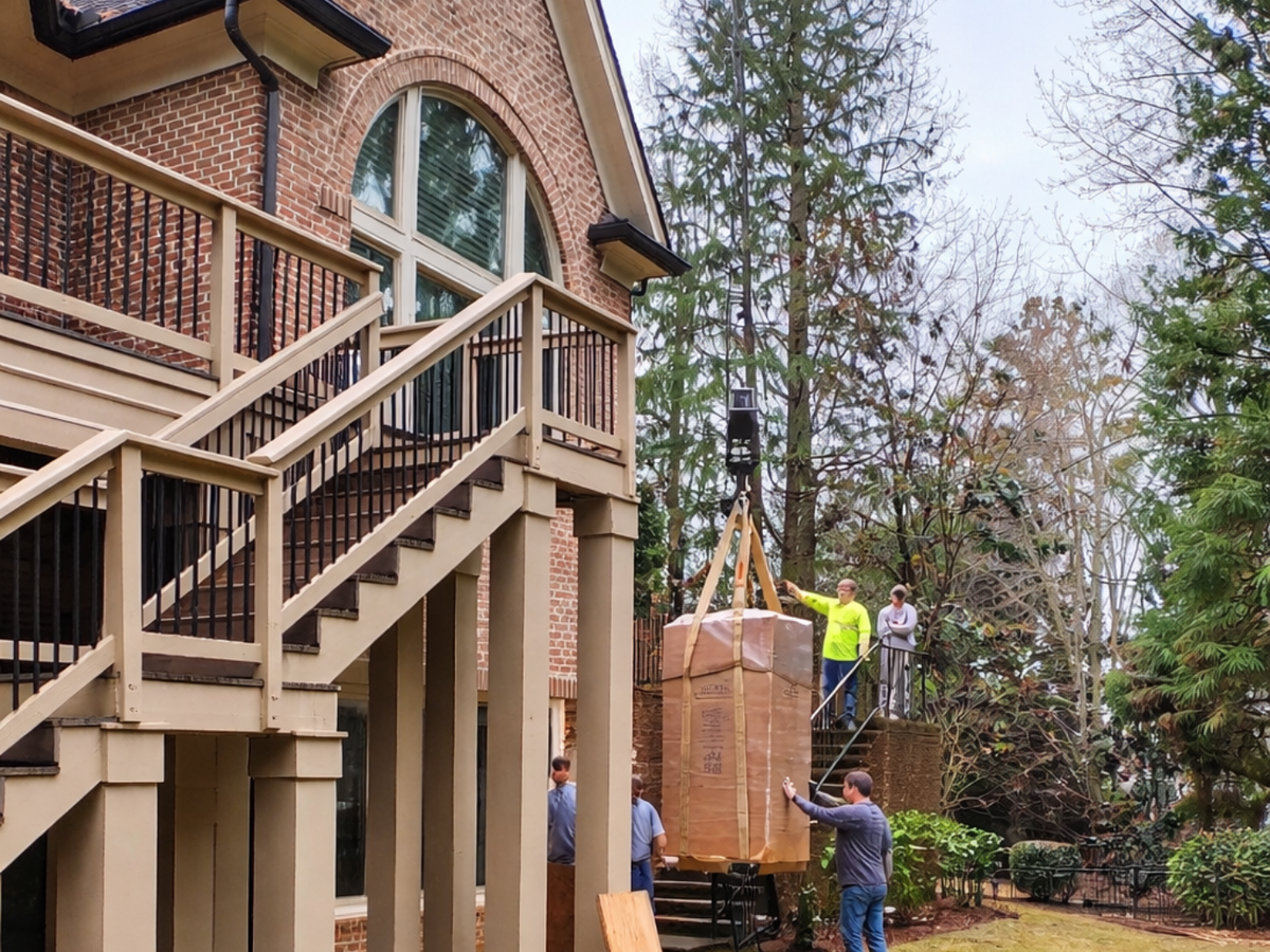 Loading safe into house on a crane