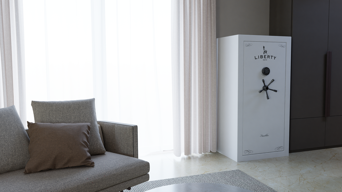 White Liberty safe placed in a living room corner beside a sofa and curtains.