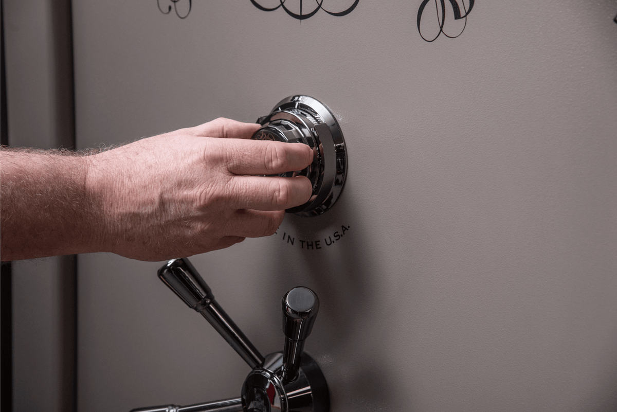 Close-up of a person turning a safe’s combination dial, representing The SafeMarket 1–10 safe security rating system.